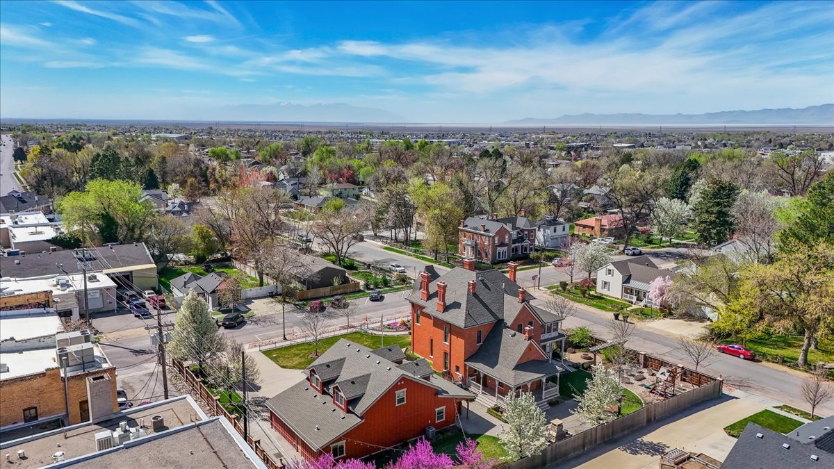 Red brick residence featuring multiple gables and prominent chimneys