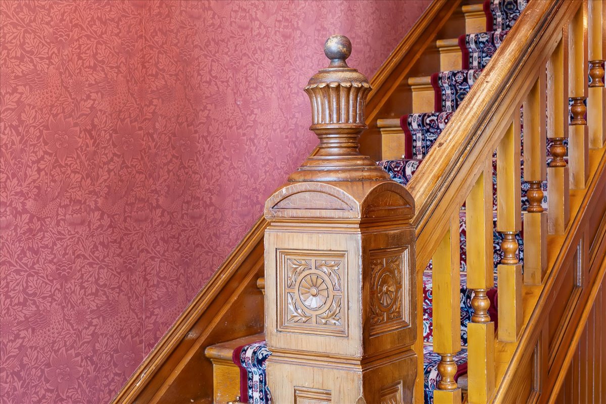 Ornate wooden newel post featuring carved detailing