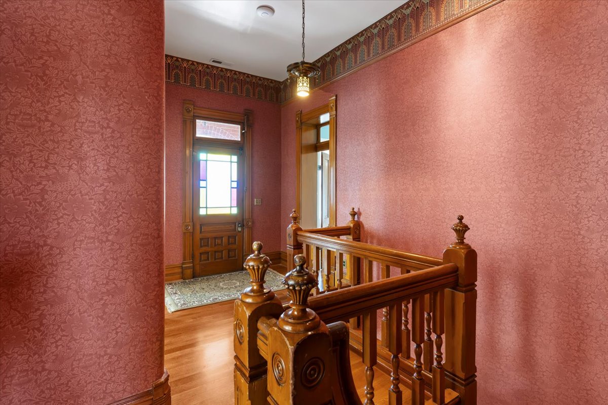 Ornate wooden staircase with turned balusters and detailed newel posts