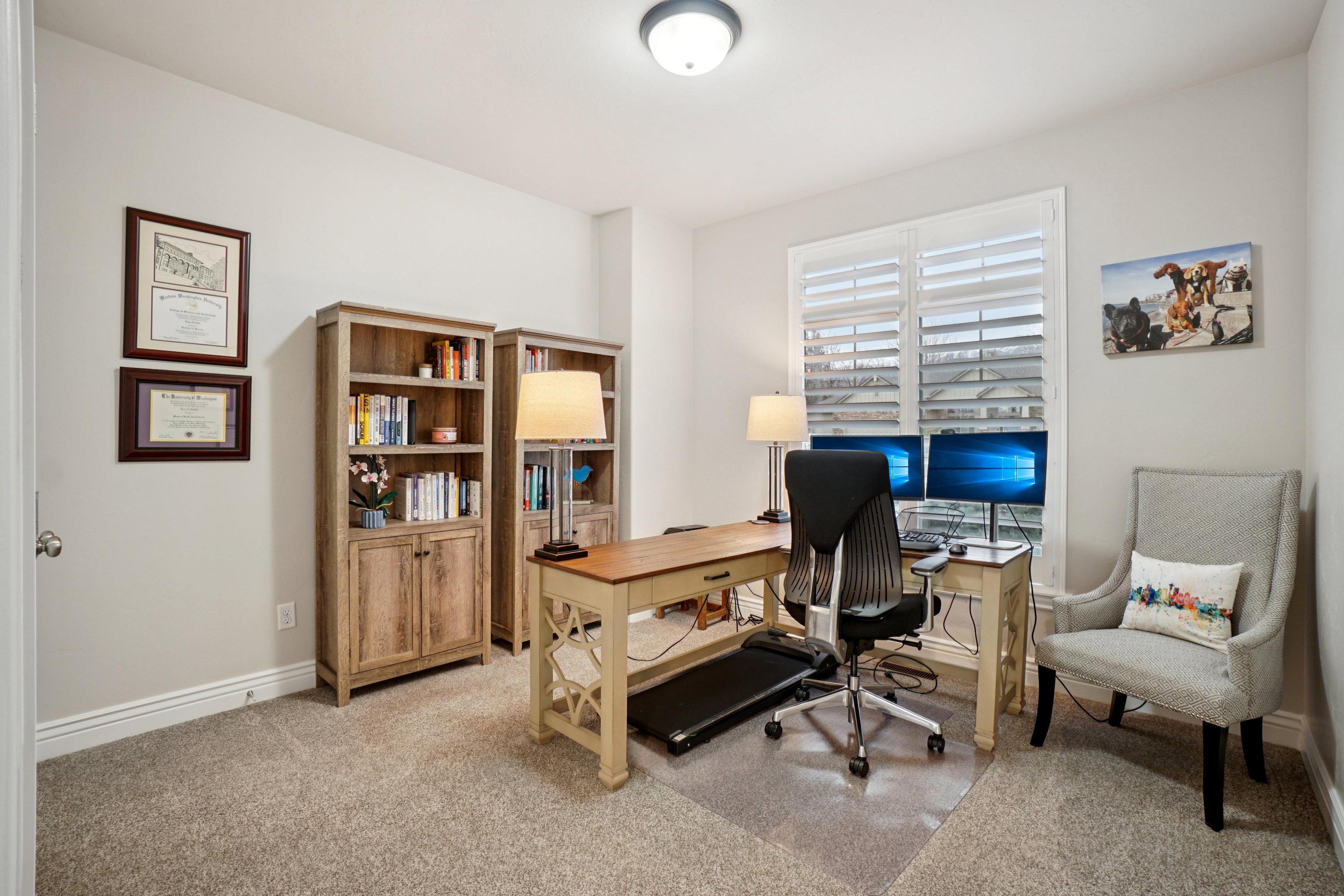 Dedicated room featuring neutral wall tones, plush carpet flooring, a flush-mount ceiling light, and window with plantation shutters