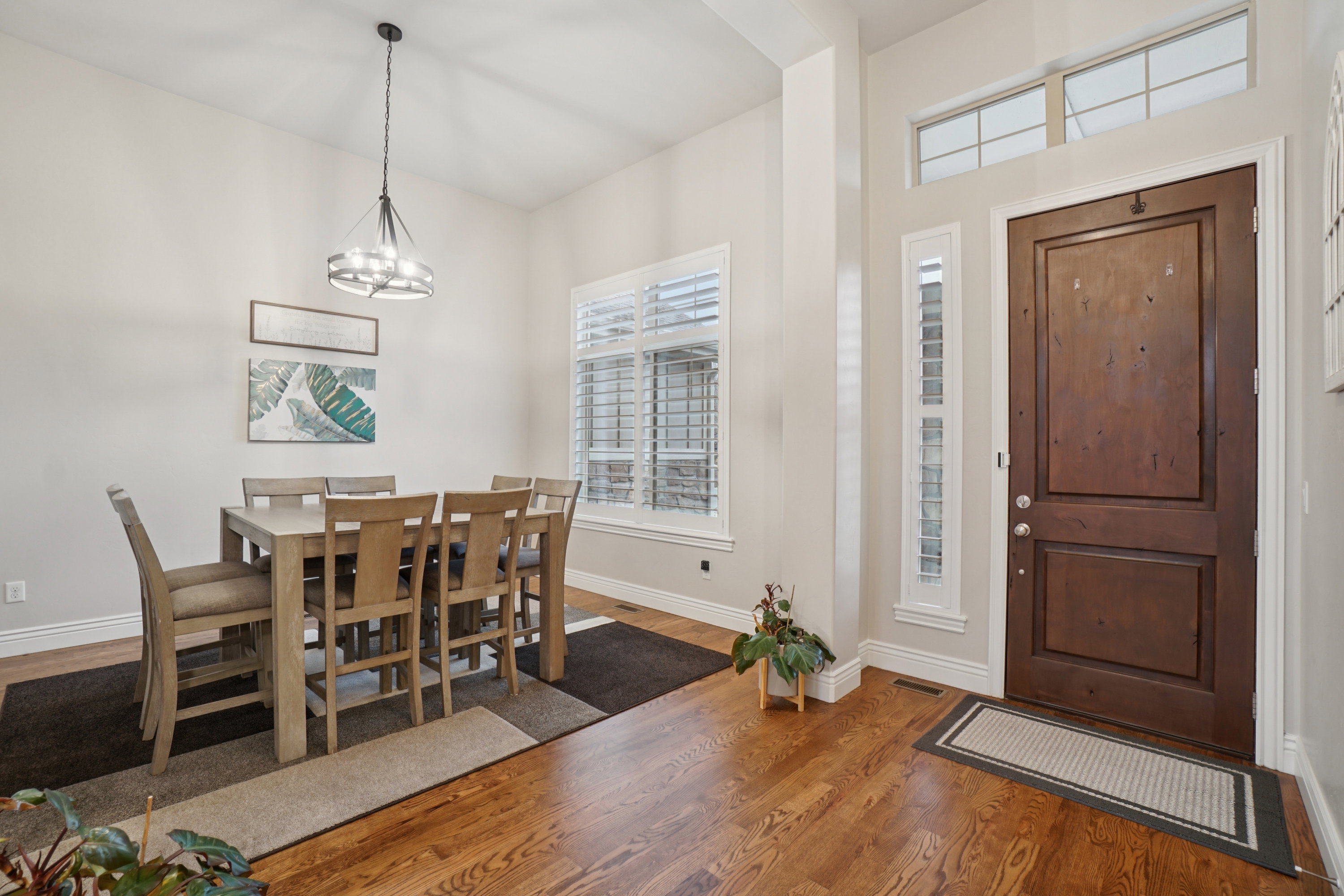 Grand entryway featuring a paneled wood door with sidelight and transom windows