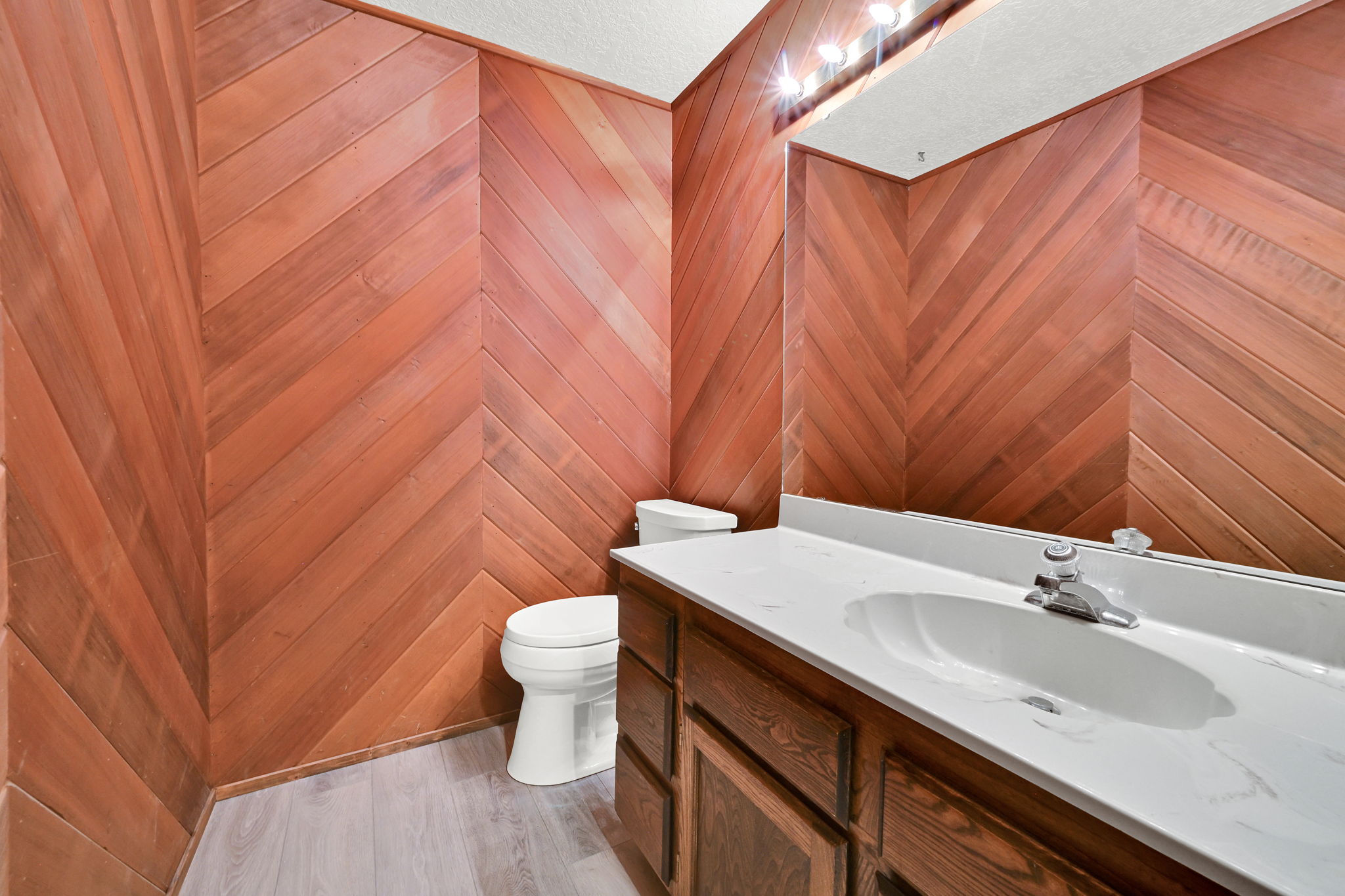 Wood-paneled walls featuring a herringbone pattern