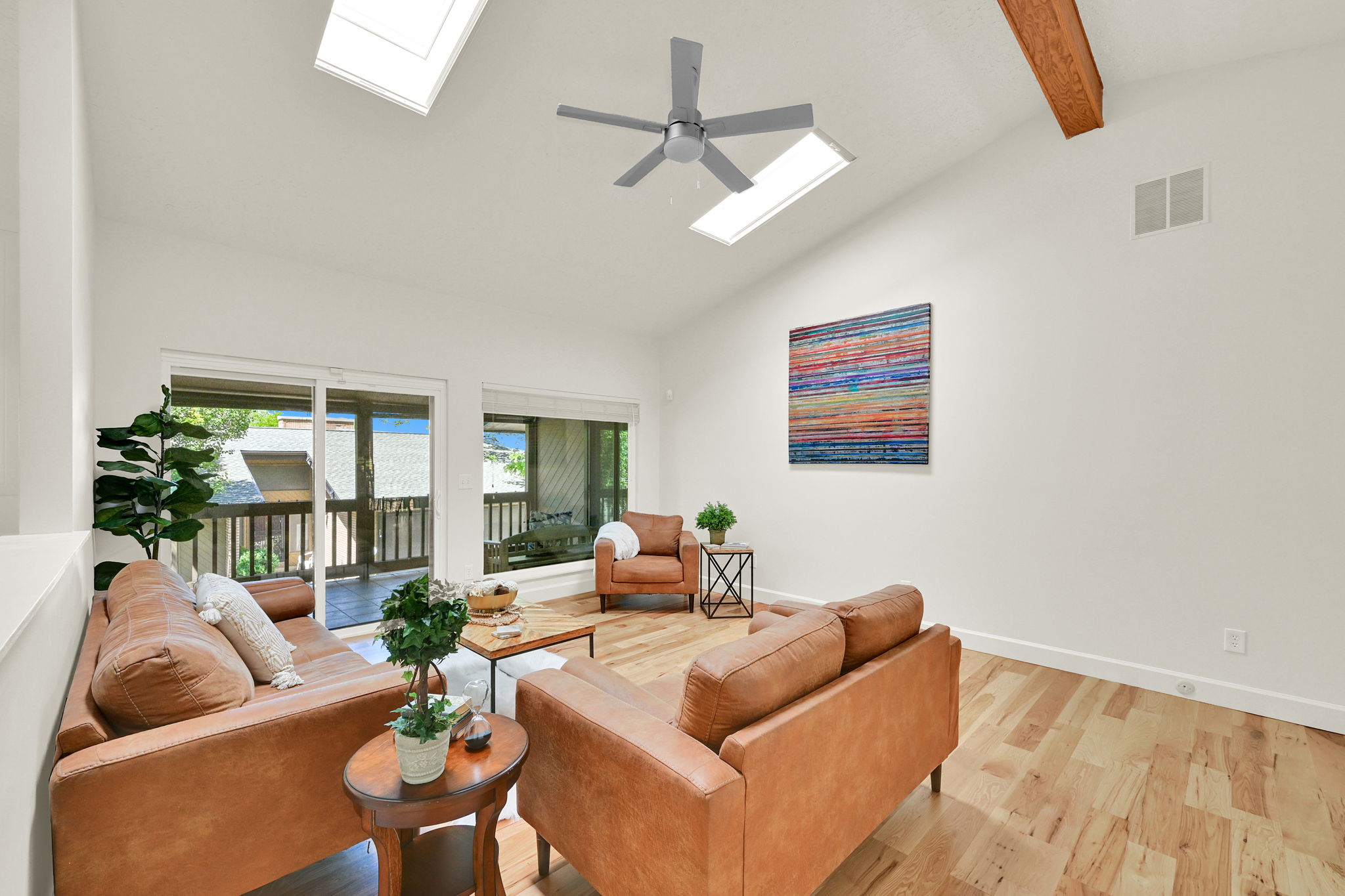 Vaulted ceilings with exposed wood beam and skylights