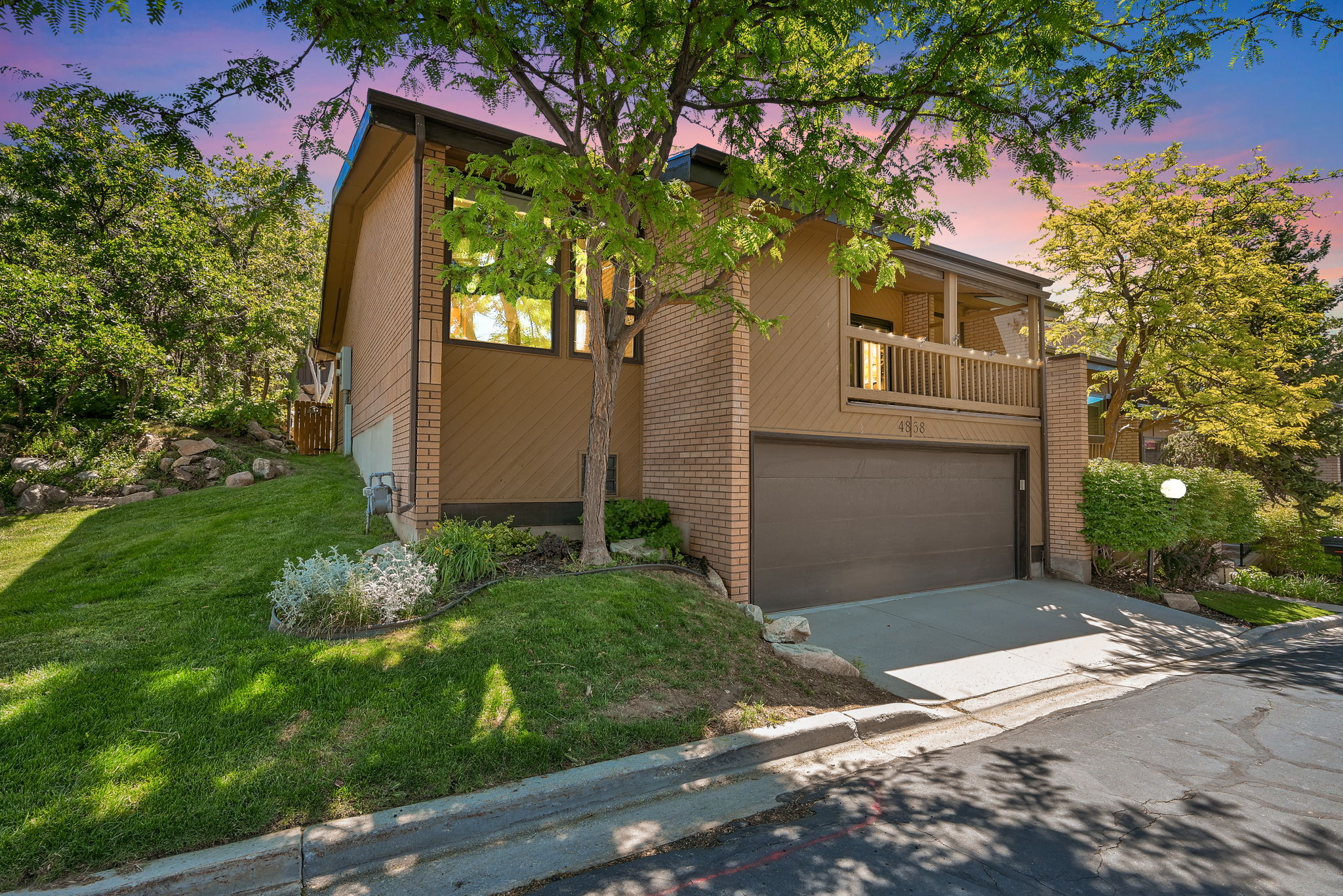 Contemporary exterior with a built-in garage and upper-level balcony