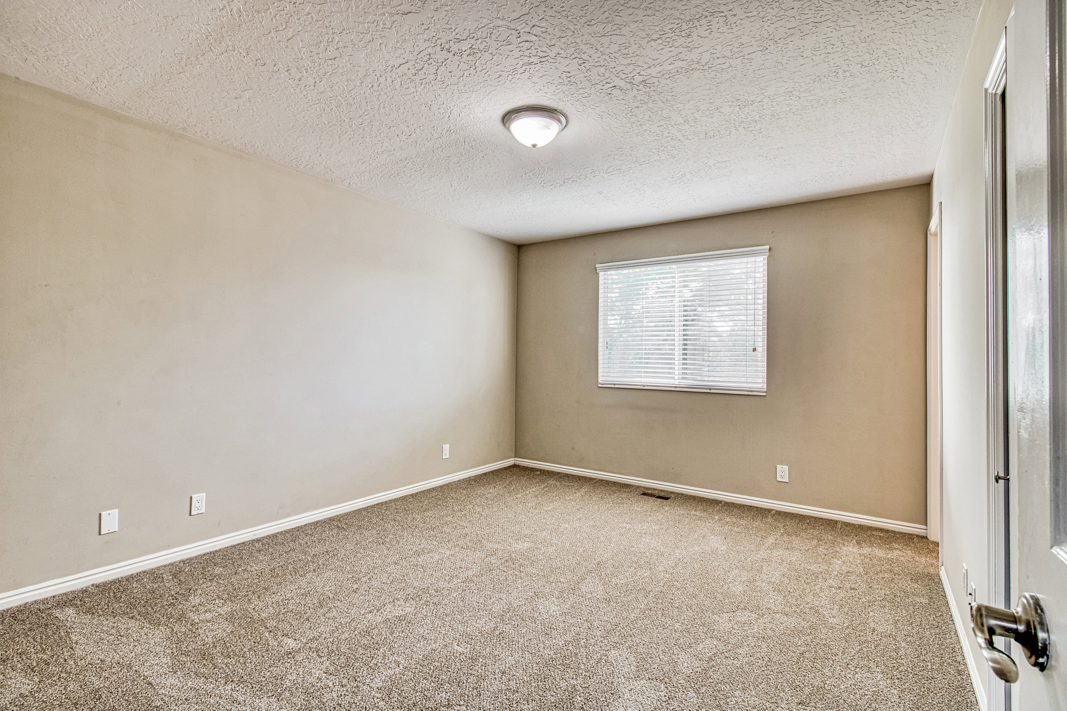 Neutral-toned walls complement the textured ceiling