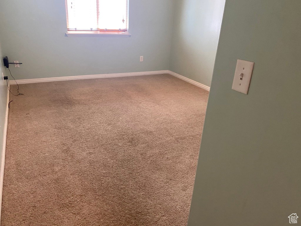 Bedroom 3: Carpeted interior space with light-colored walls and white baseboards