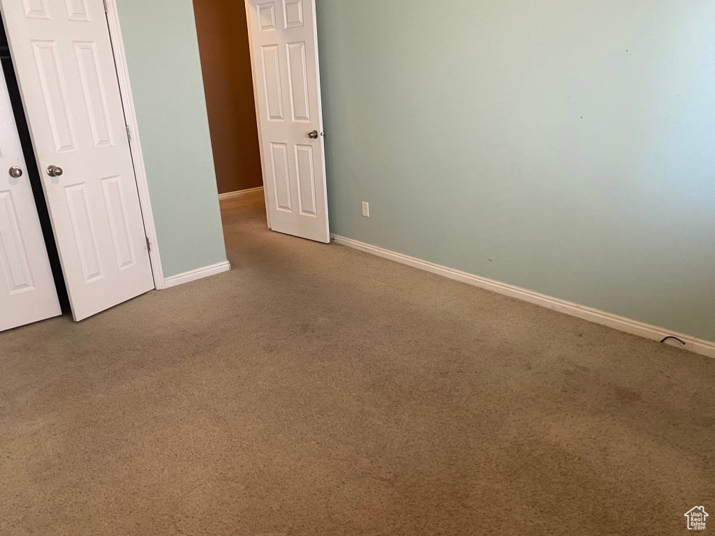 Bedroom 3: Carpeted room featuring a light green wall color and white baseboards