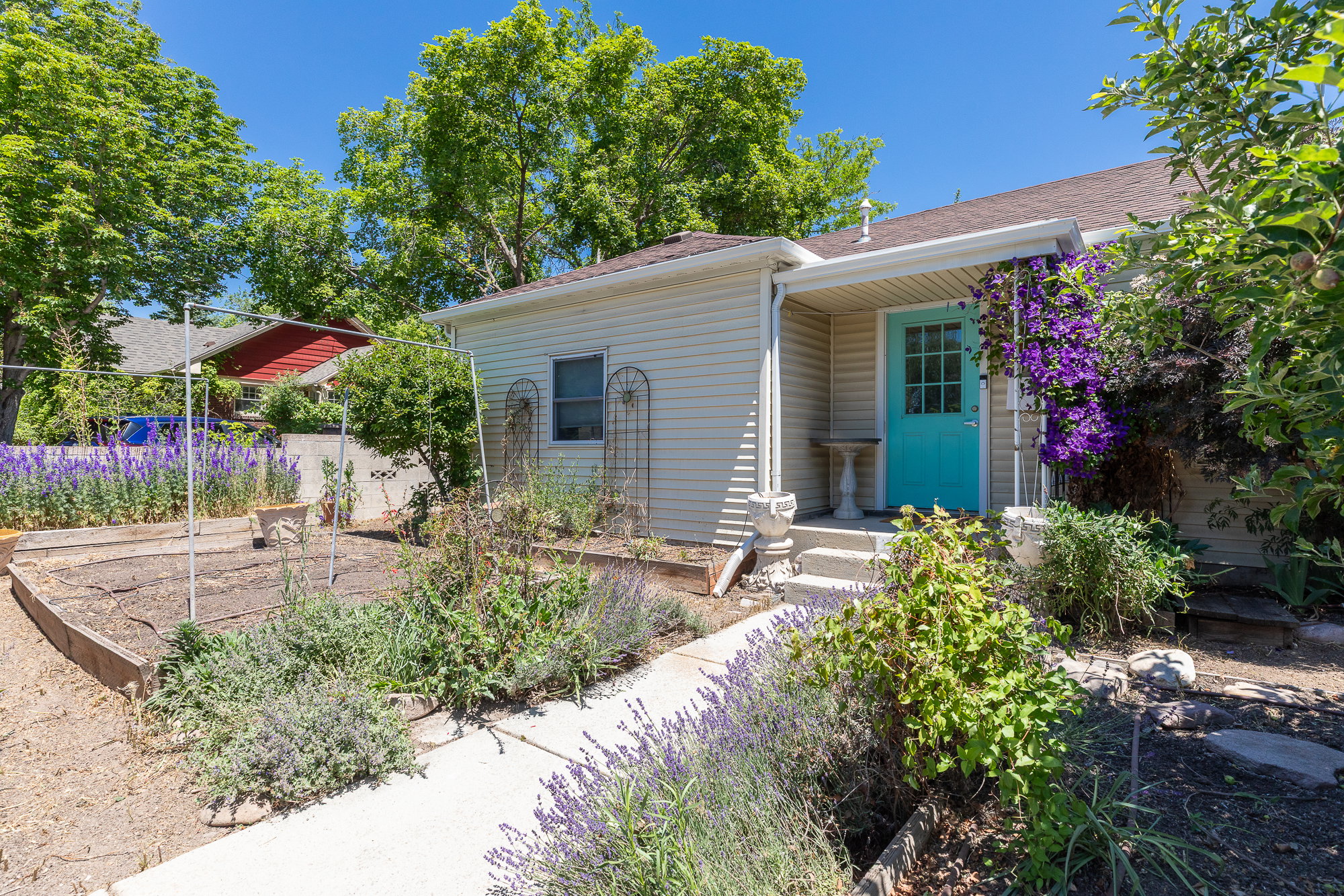 Inviting entry with a vibrant turquoise door and covered porch