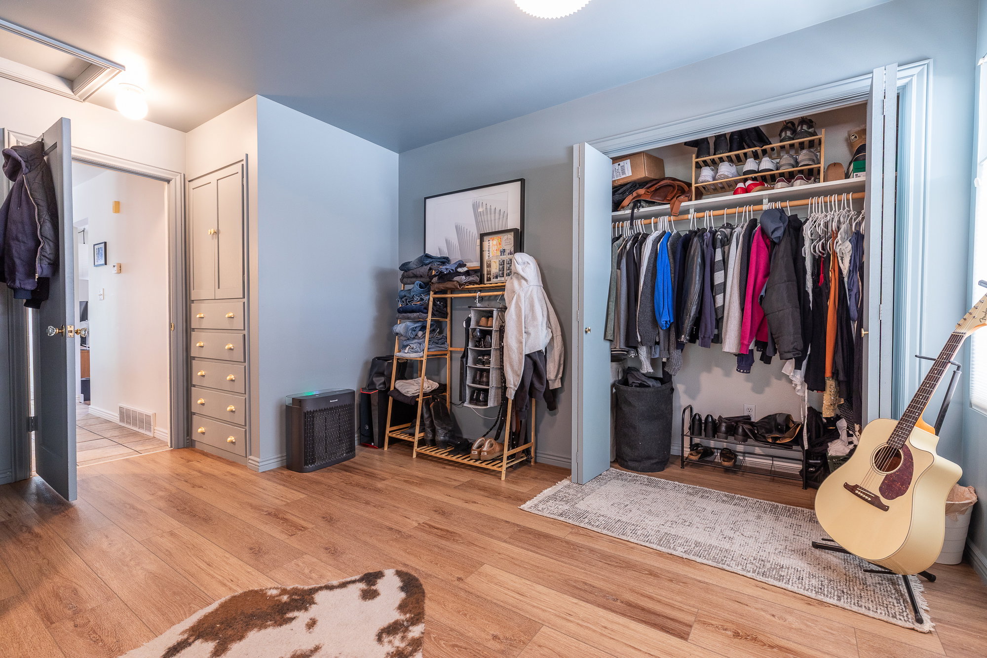 Wood-finish flooring throughout, complemented by a built-in closet featuring bi-fold doors