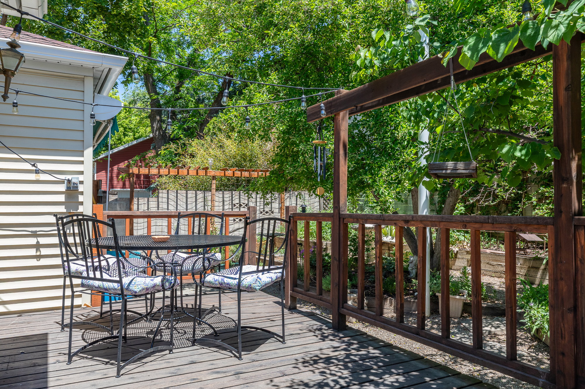 Spacious outdoor deck featuring wood-finish flooring, a built-in pergola, and a privacy fence