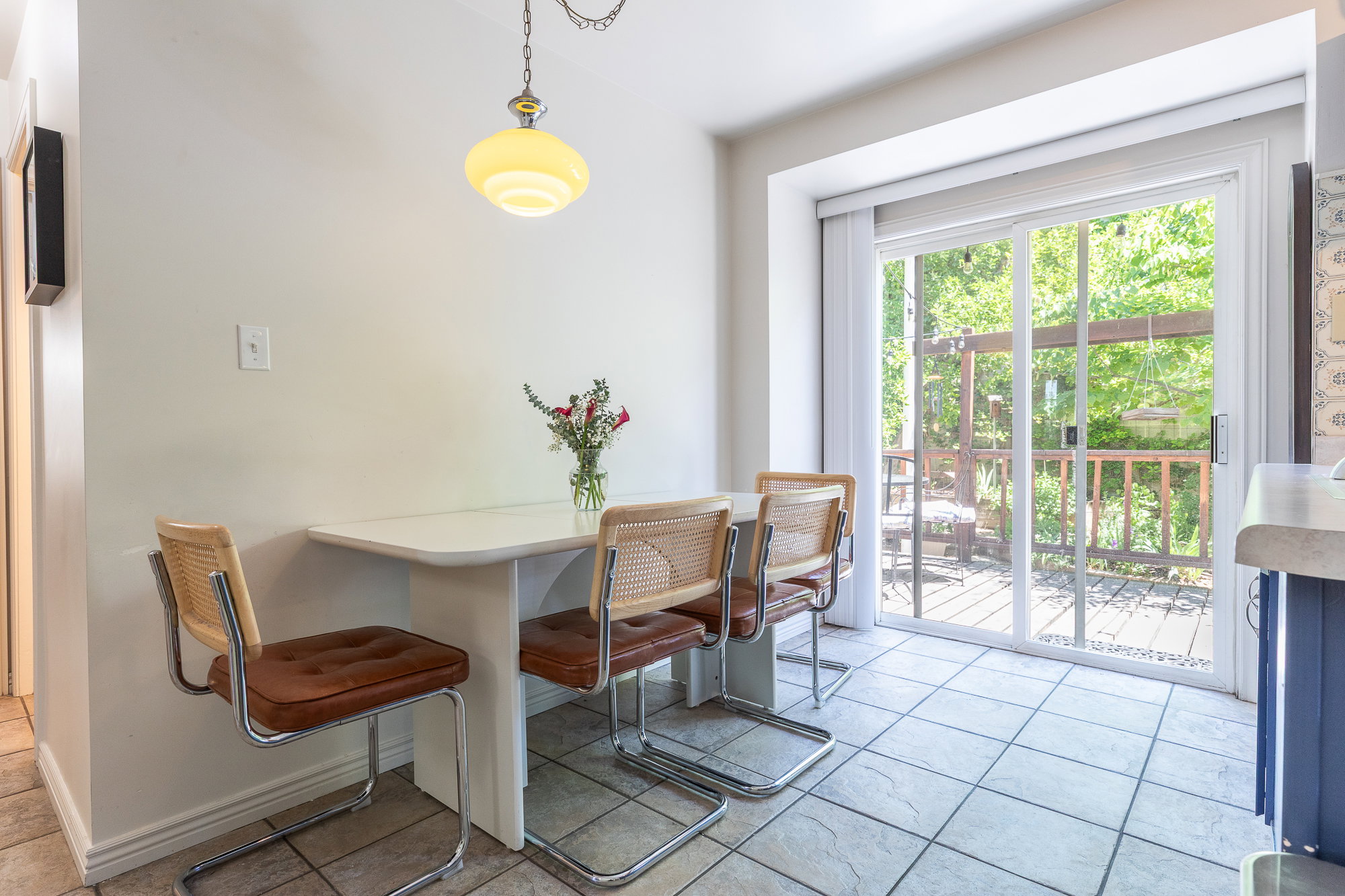 Sliding glass door opening to an exterior wood deck