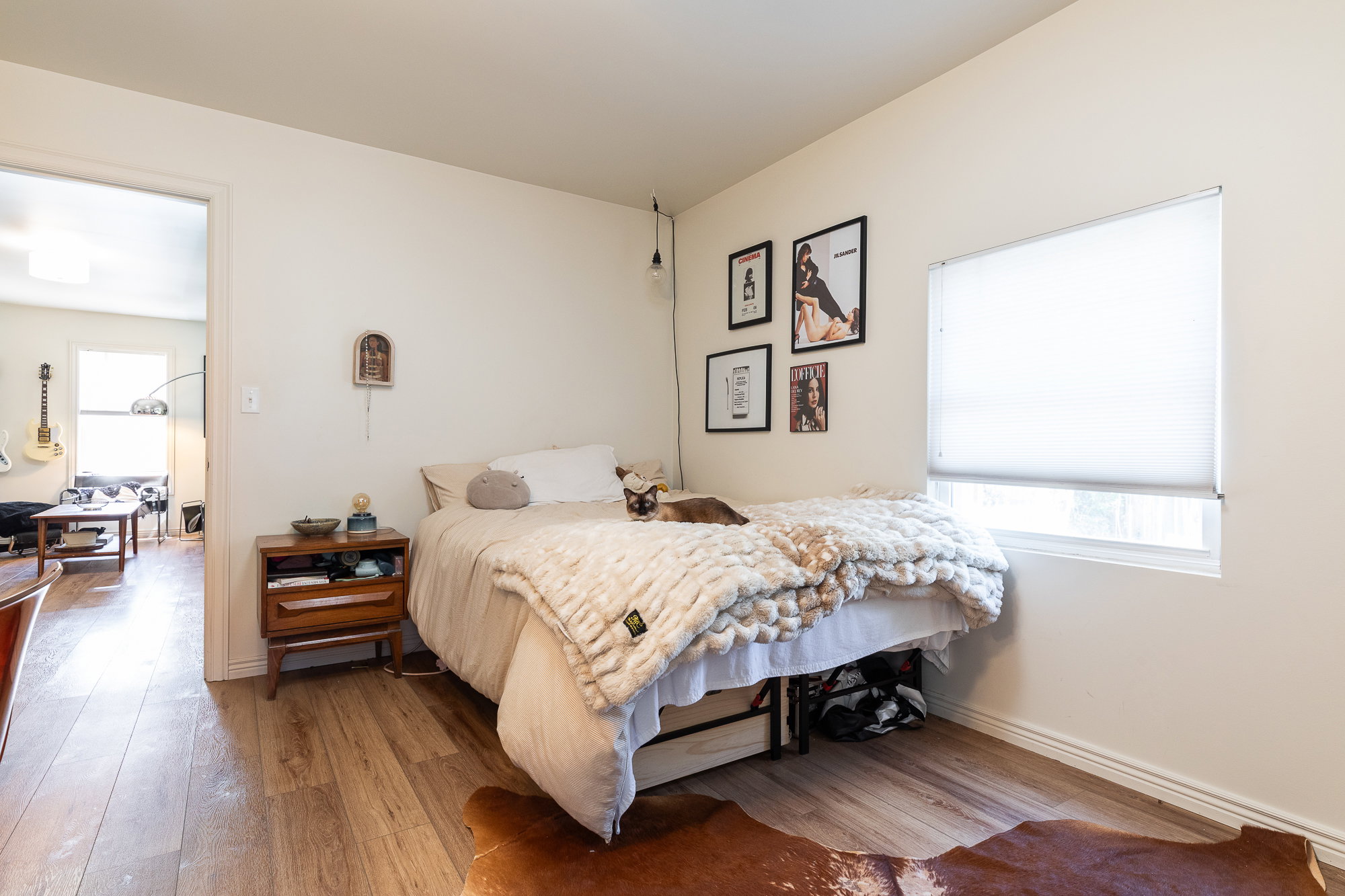 Light-toned wood-finish flooring complements white walls