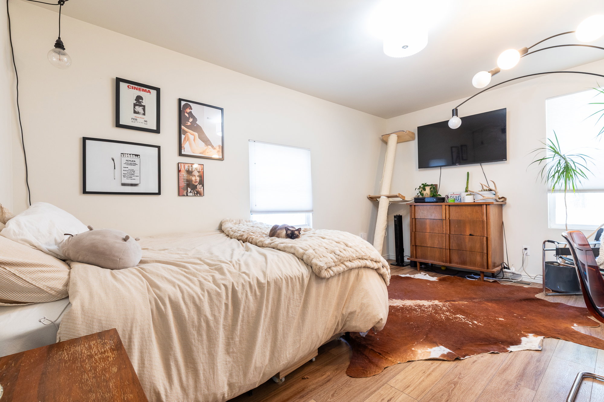 Light-toned wood-finish flooring complements the neutral wall color