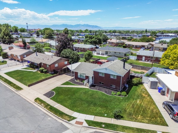Corner lot property featuring a red brick exterior with white trim