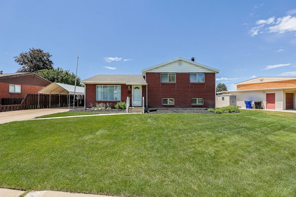 Red brick exterior with white trim and a gabled roof