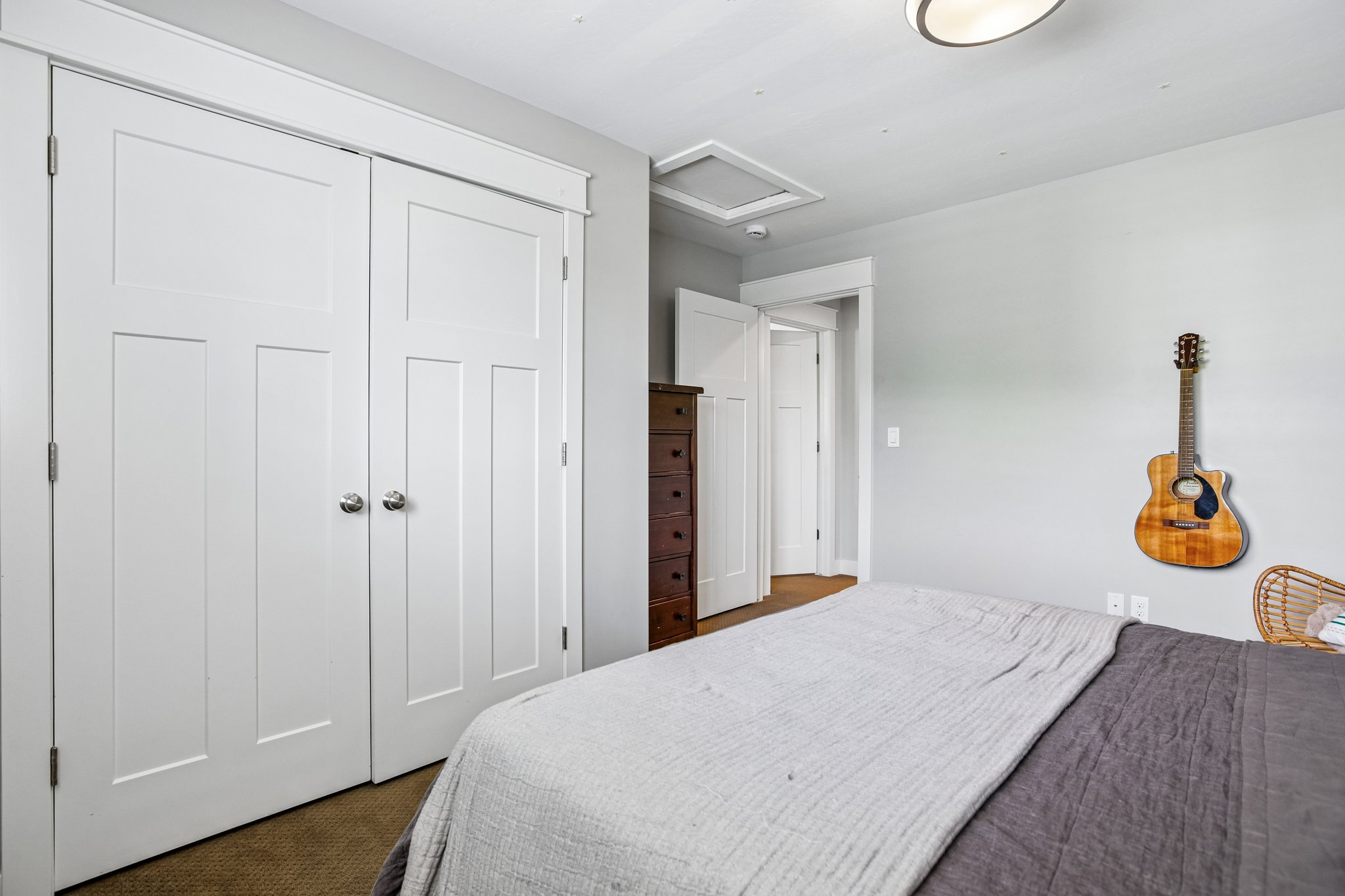 White paneled bi-fold closet doors with chrome hardware