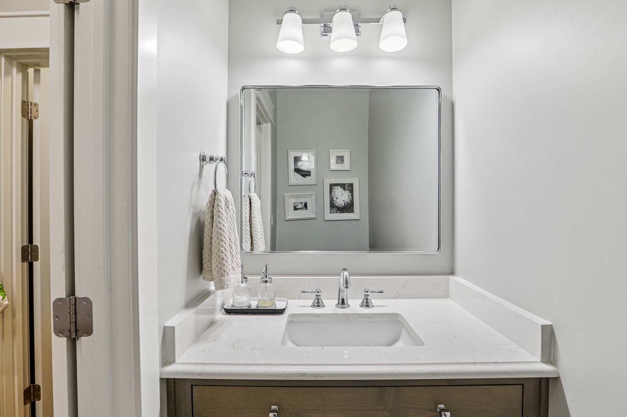 Vanity with a quartz countertop and integrated rectangular sink