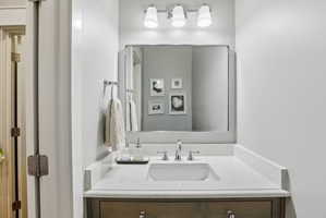 Vanity with a quartz countertop and integrated rectangular sink