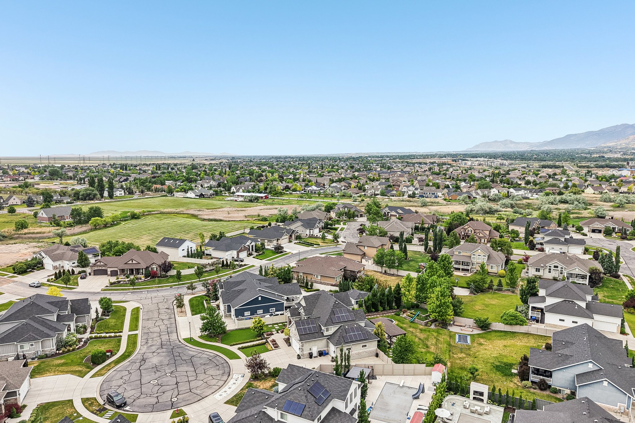 Aerial perspective showcasing a residential community with varied home styles and expansive green spaces