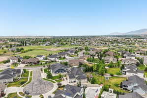 Aerial perspective showcasing a residential community with varied home styles and expansive green spaces