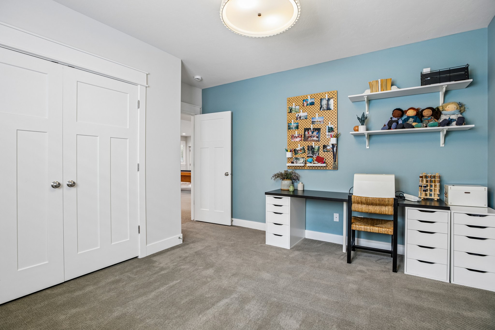 Spacious room featuring neutral carpet flooring, a light blue accent wall, recessed lighting, and white trim