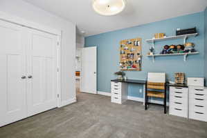 Spacious room featuring neutral carpet flooring, a light blue accent wall, recessed lighting, and white trim