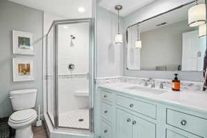 Bathroom featuring a glass-enclosed shower with white subway tile, a built-in shower bench, and a mosaic tile accent strip