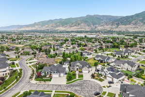 Expansive residential community featuring a variety of architectural styles, mature landscaping, and mountain backdrops