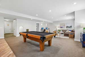 Spacious lower-level entertainment area featuring recessed lighting
