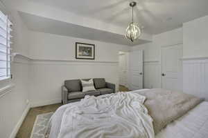 Bright room featuring white wainscoting and plantation shutters