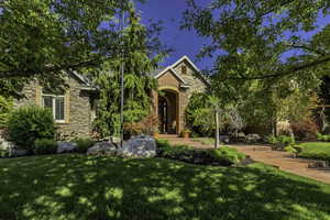 Stone and brick exterior featuring a prominent arched entryway