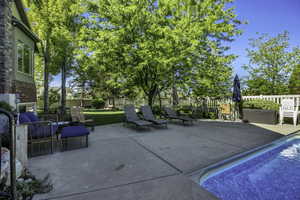 Expansive concrete patio area with an in-ground swimming pool