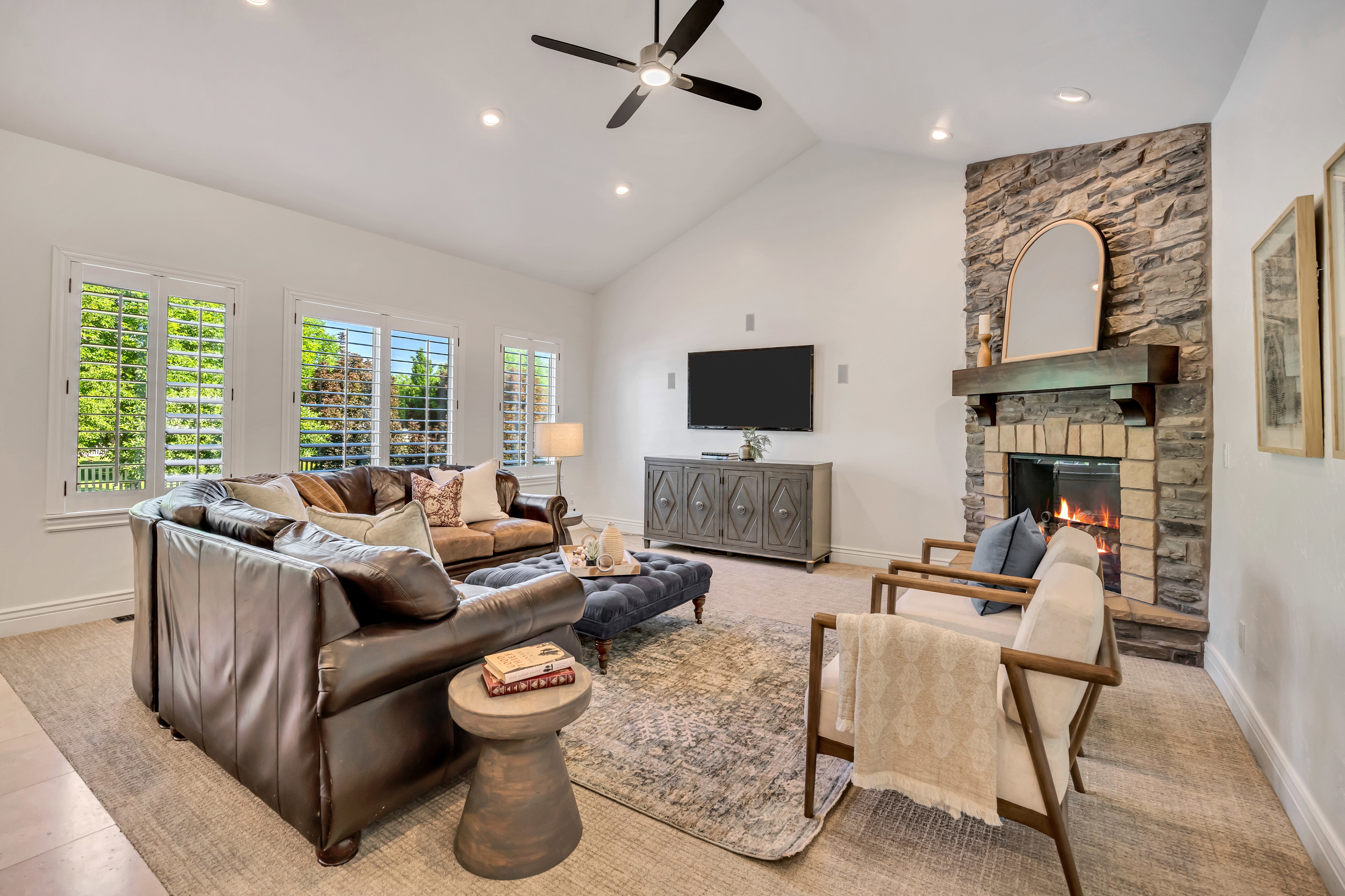 Vaulted ceilings with recessed lighting and a ceiling fan