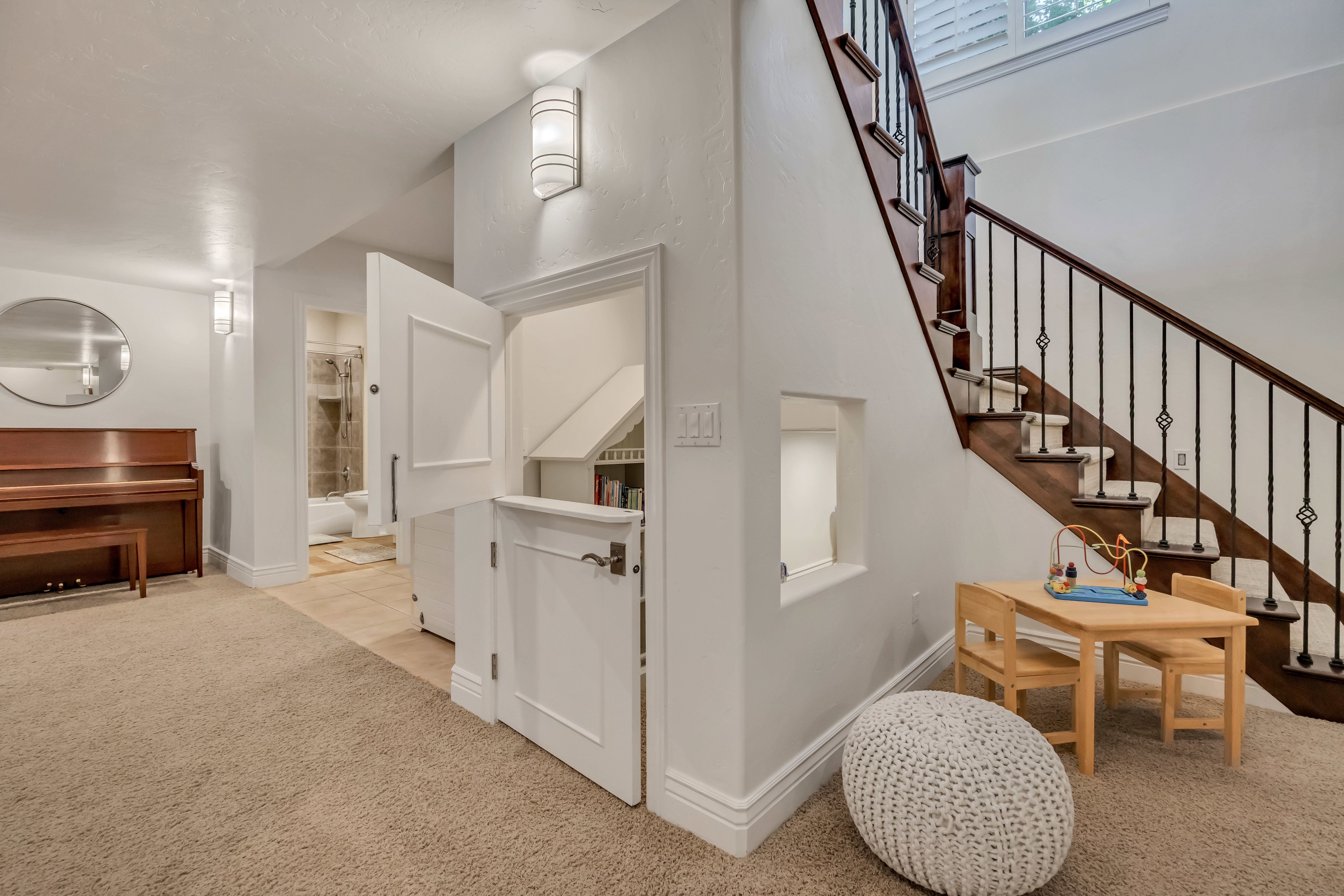 Staircase featuring dark wood treads and an ornate iron railing