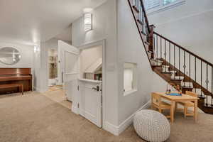 Staircase featuring dark wood treads and an ornate iron railing