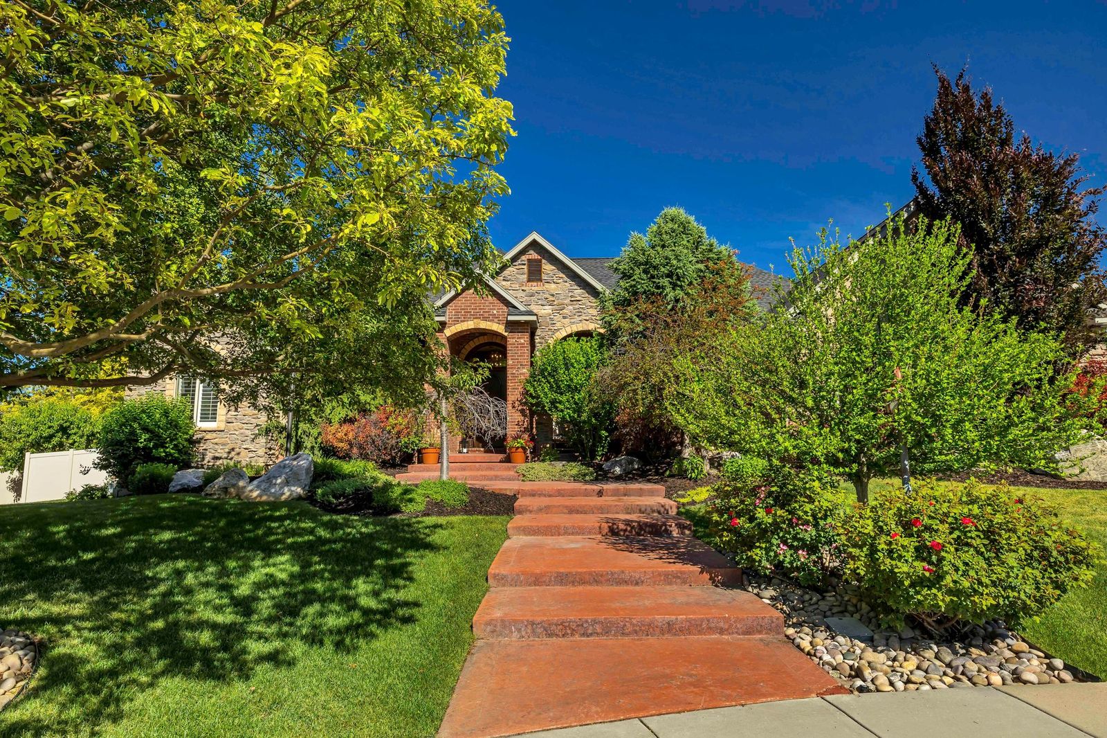 Stone and brick exterior featuring a prominent arched entry