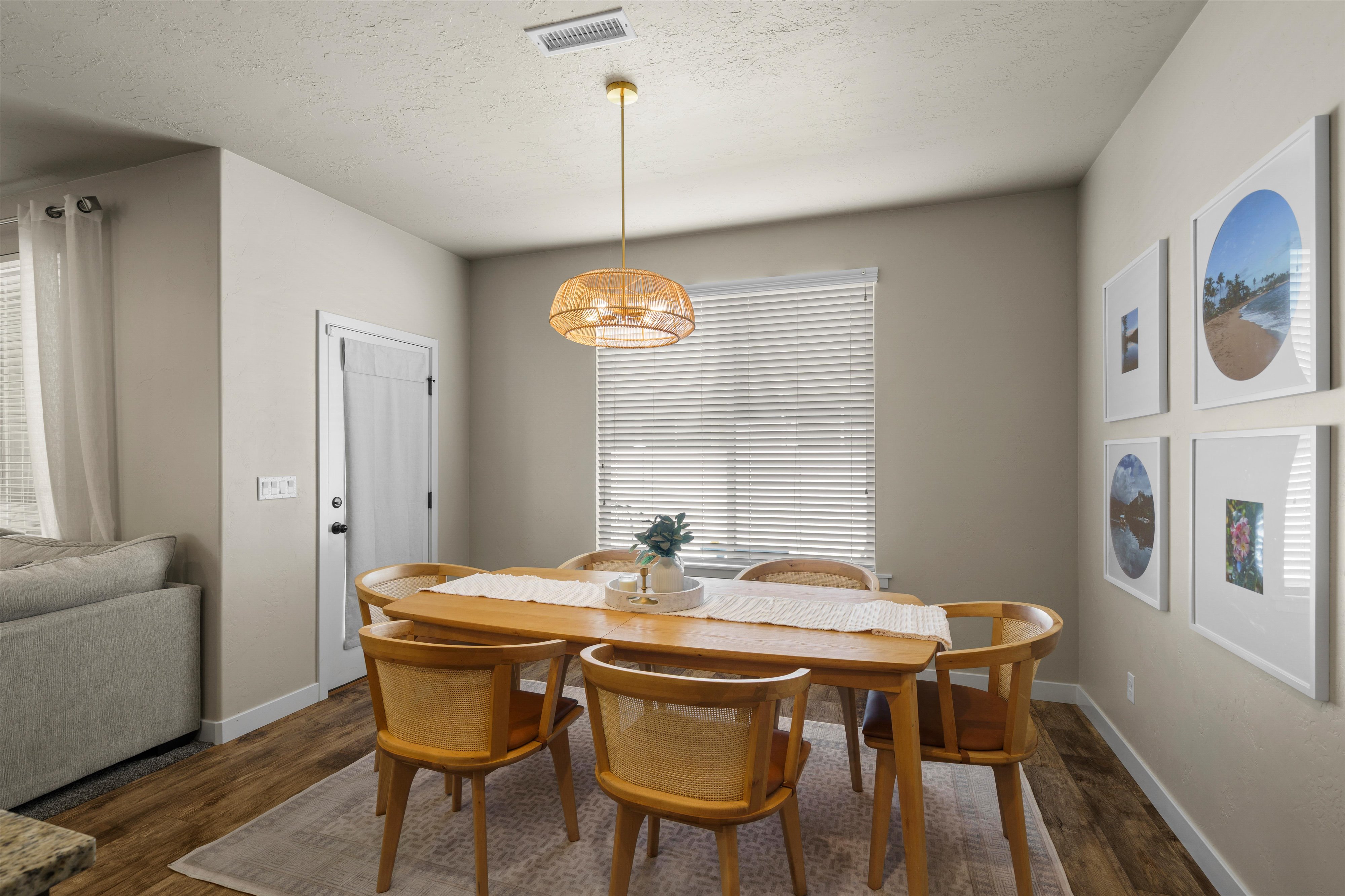 Dining area featuring wood-finish flooring and a decorative ceiling light fixture