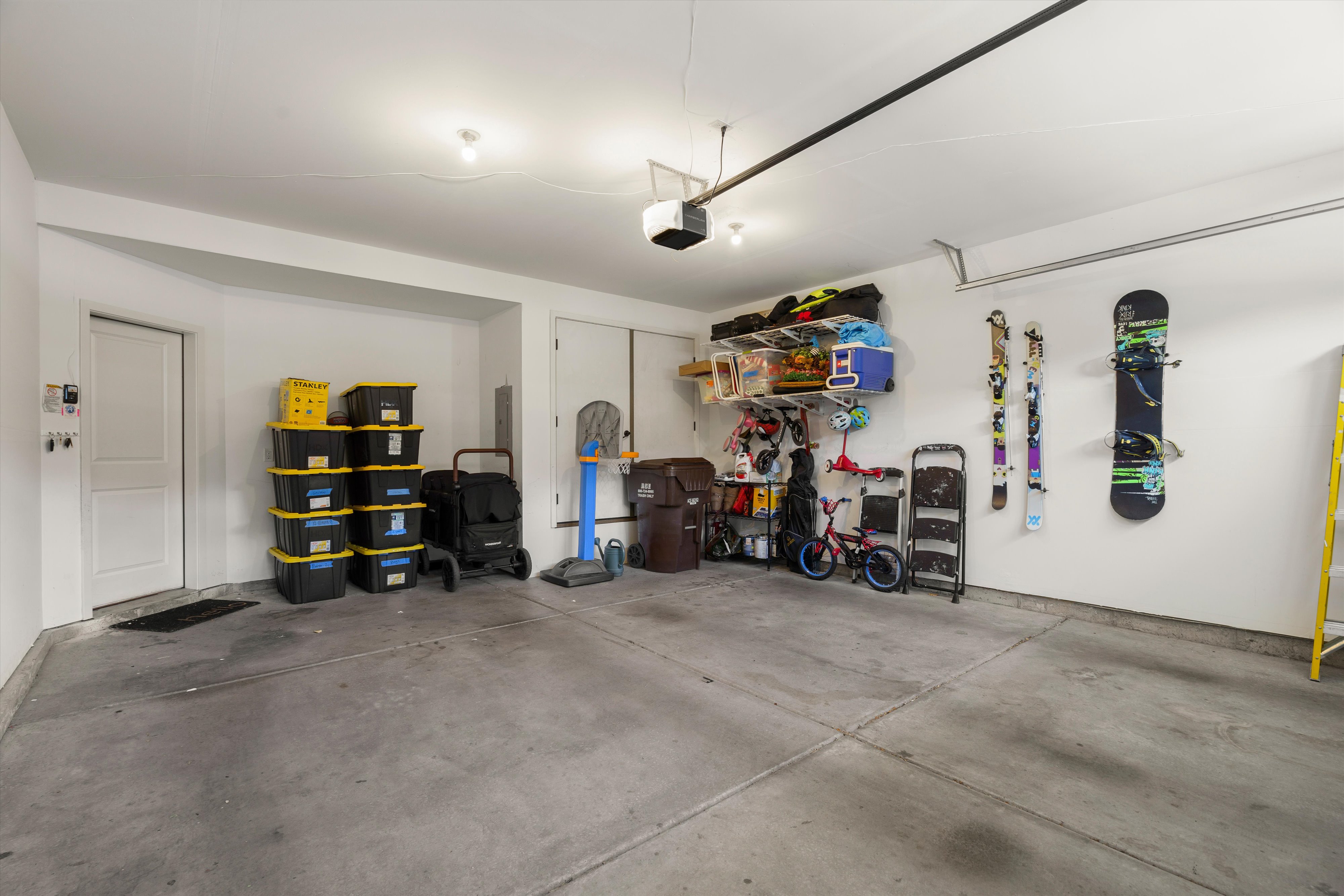 Spacious garage featuring a concrete floor, painted walls, and overhead lighting