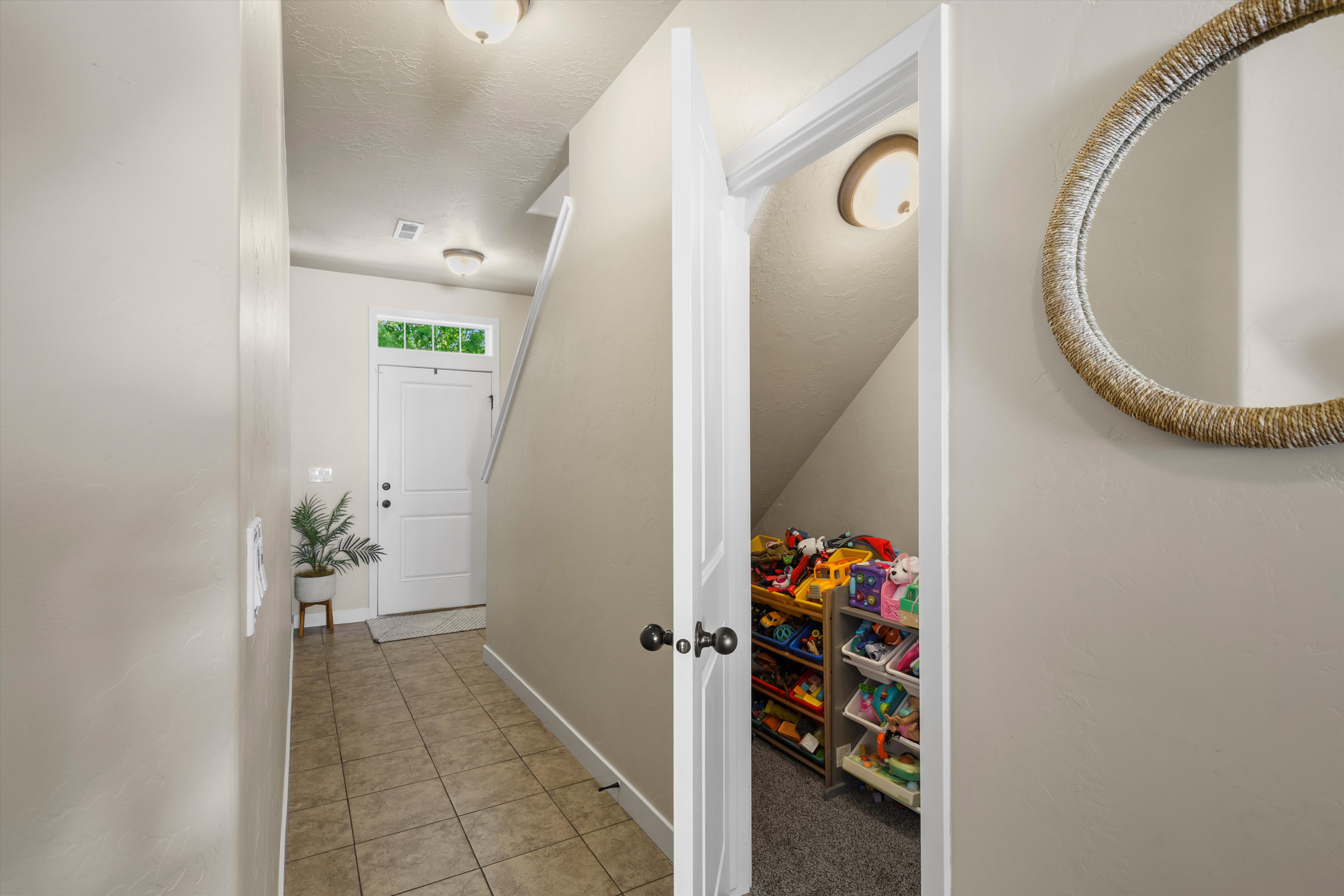 Entryway featuring tile flooring, a white paneled door with transom window, and flush-mount ceiling lighting