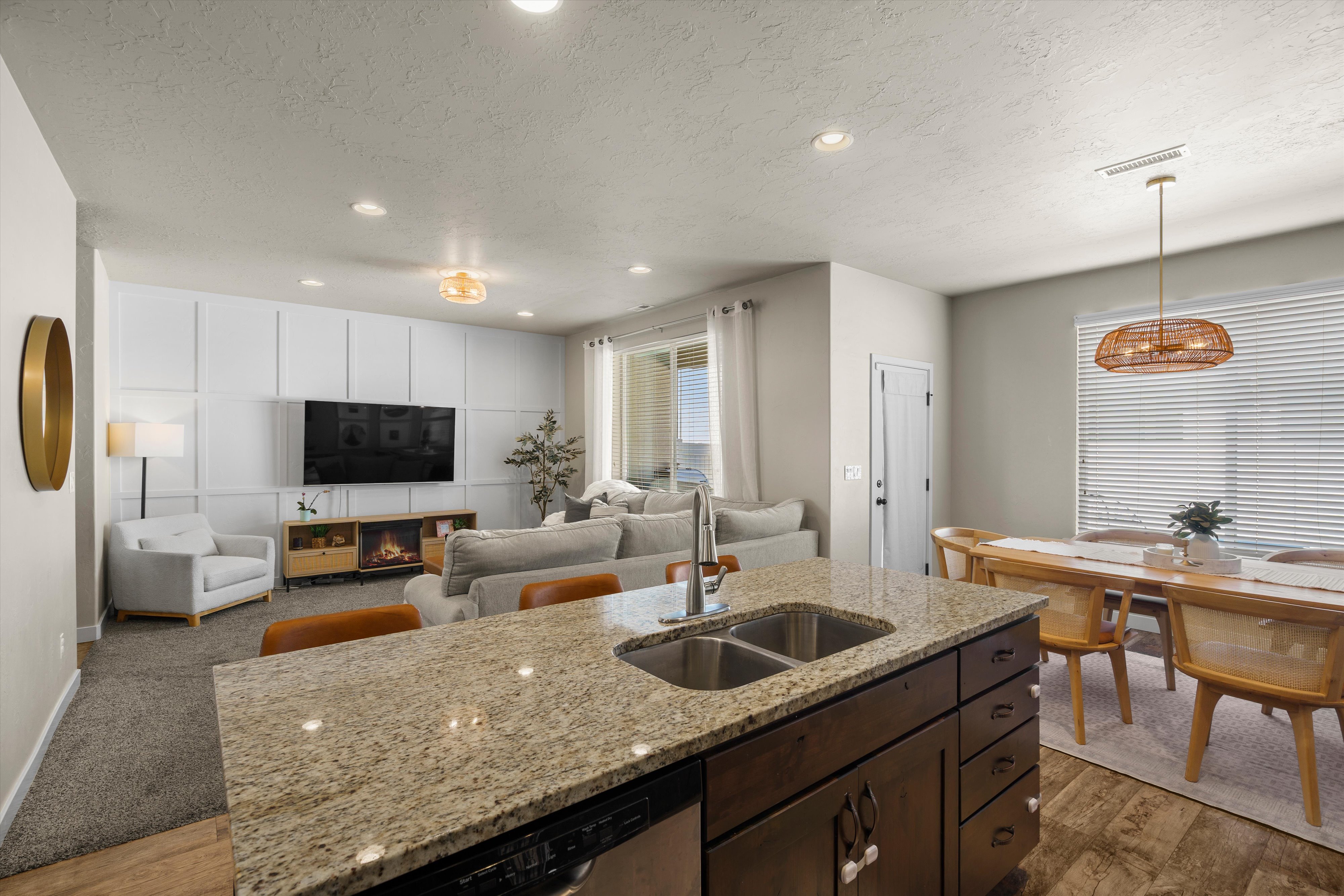Kitchen island featuring a granite countertop and dual basin stainless steel sink