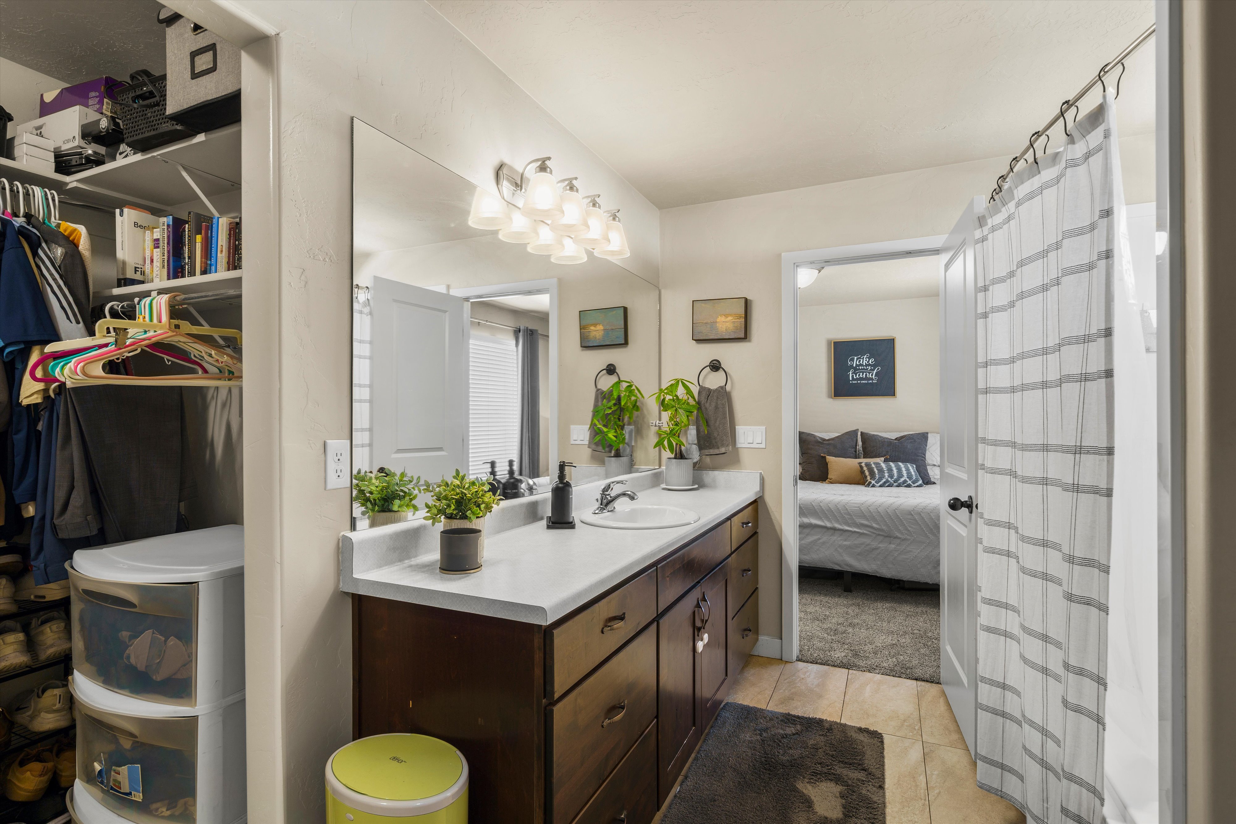 Bathroom vanity featuring a single sink, white countertop, and dark wood-finish cabinetry with multiple drawers