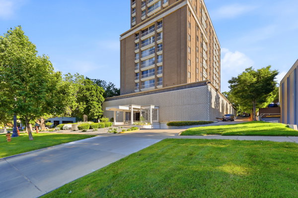 Mid-rise building featuring a brick exterior and multiple private balconies