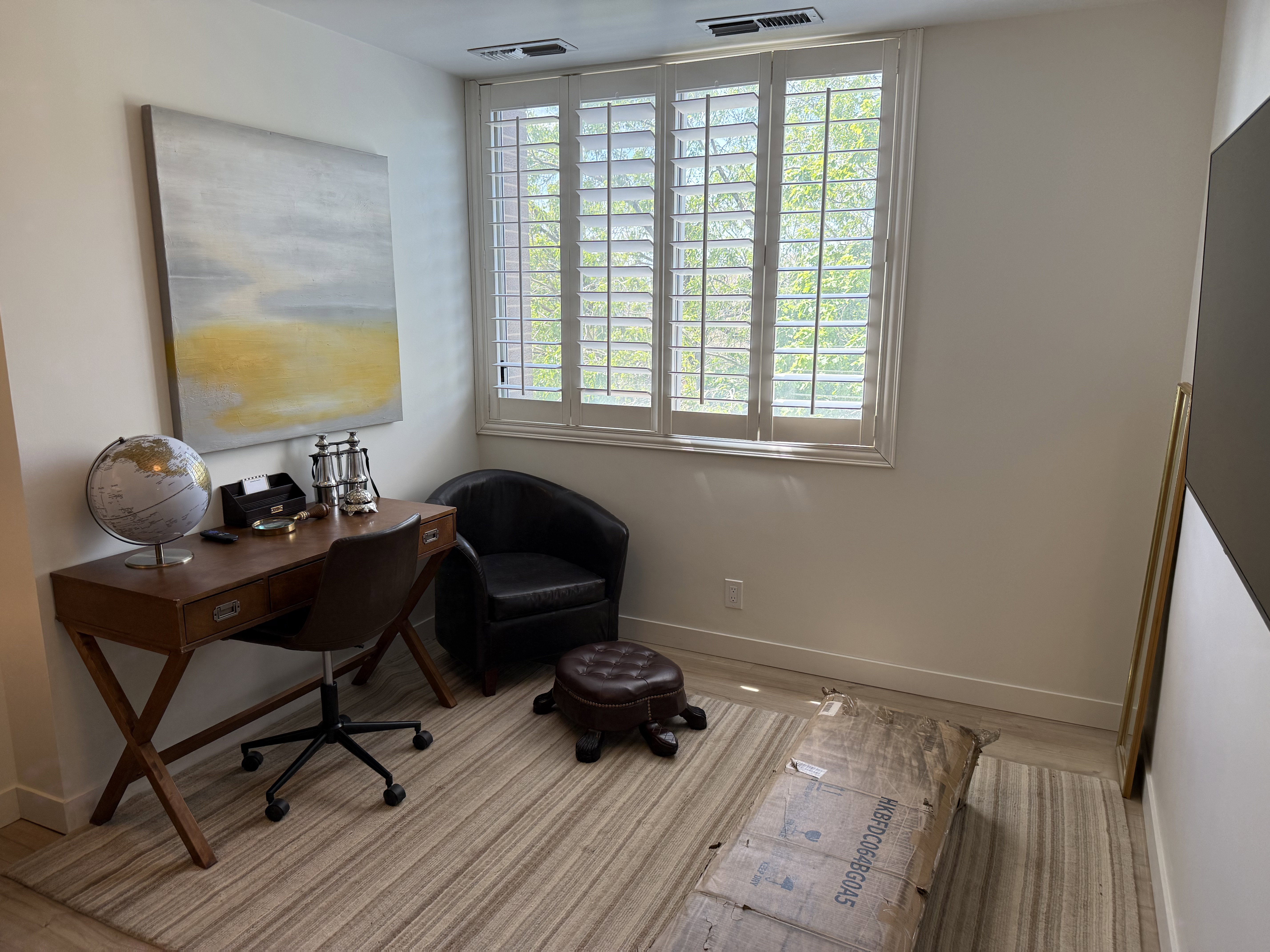White walls complementing a window with white louvered shutters