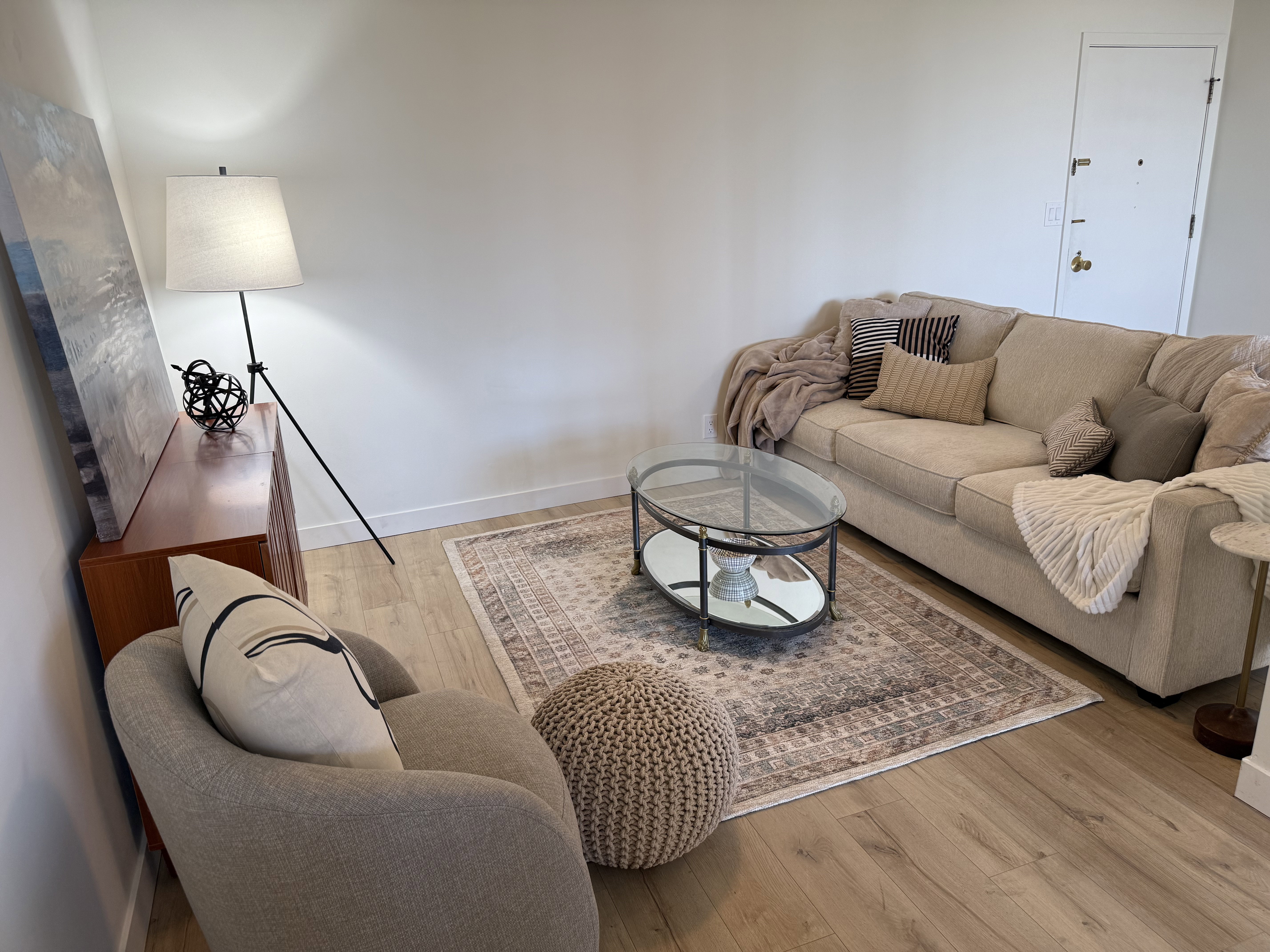 Light wood-finish flooring complements the neutral wall color