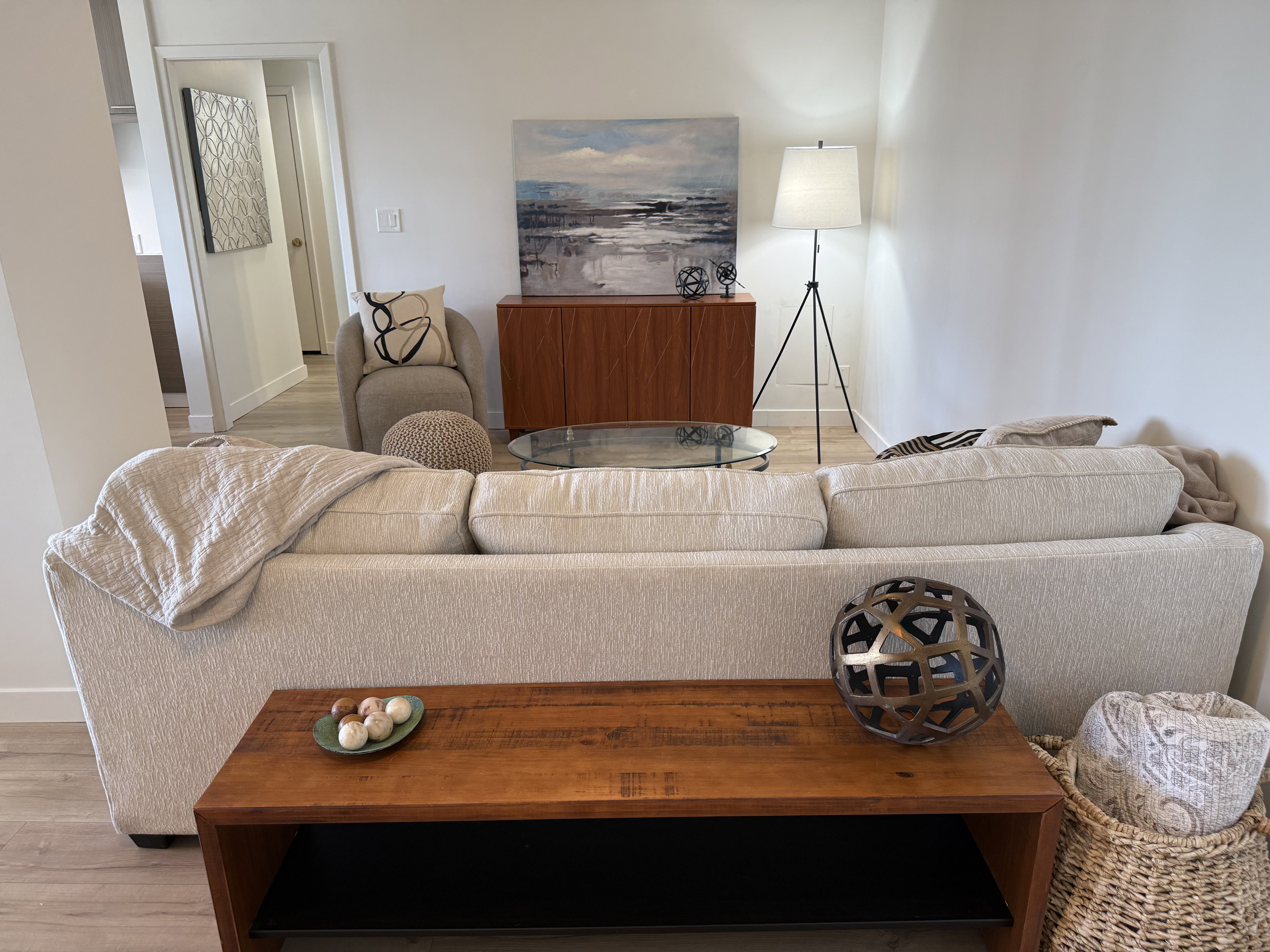 Living space featuring light wood-finish flooring, white walls, and a neutral color palette