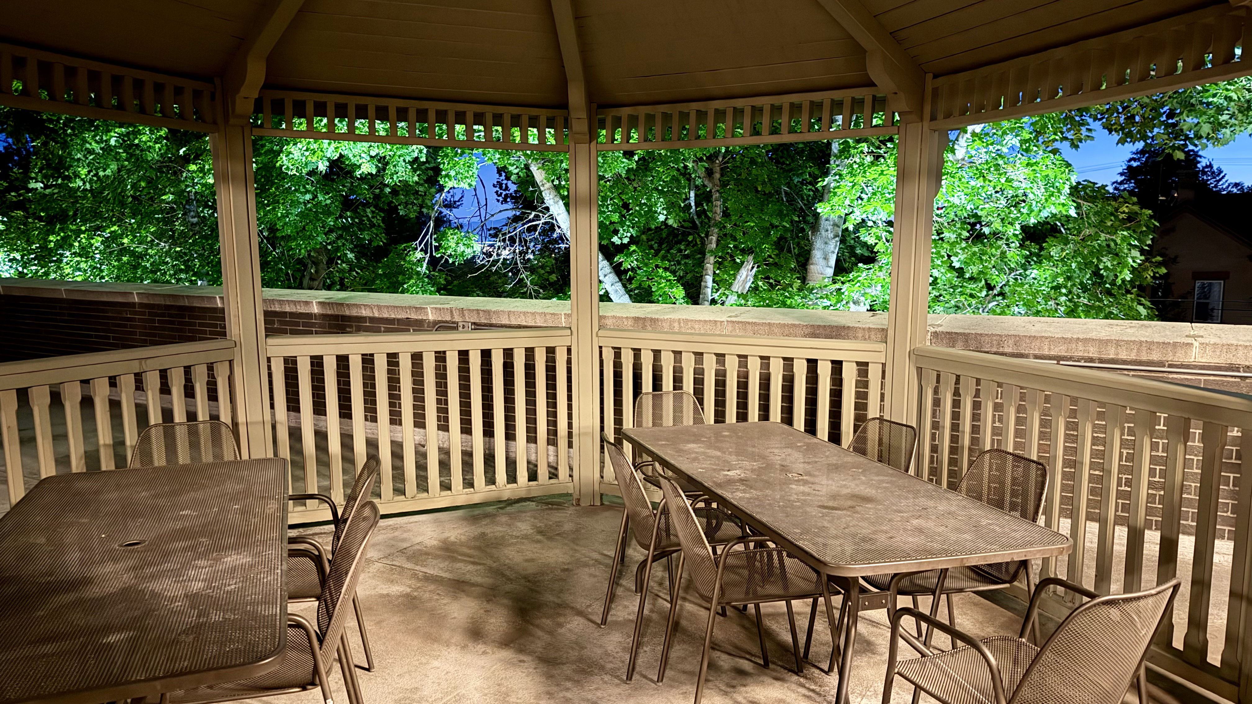 Gazebo structure featuring open-slat railings and an open lattice ceiling
