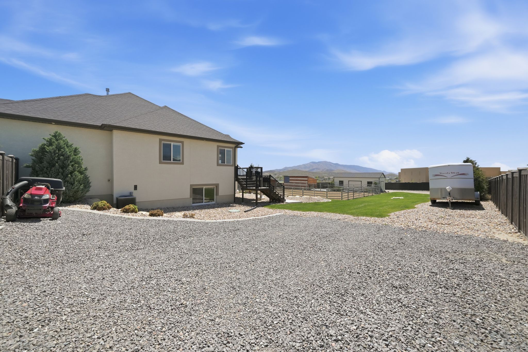 Expansive gravel area with ample space for vehicle parking
