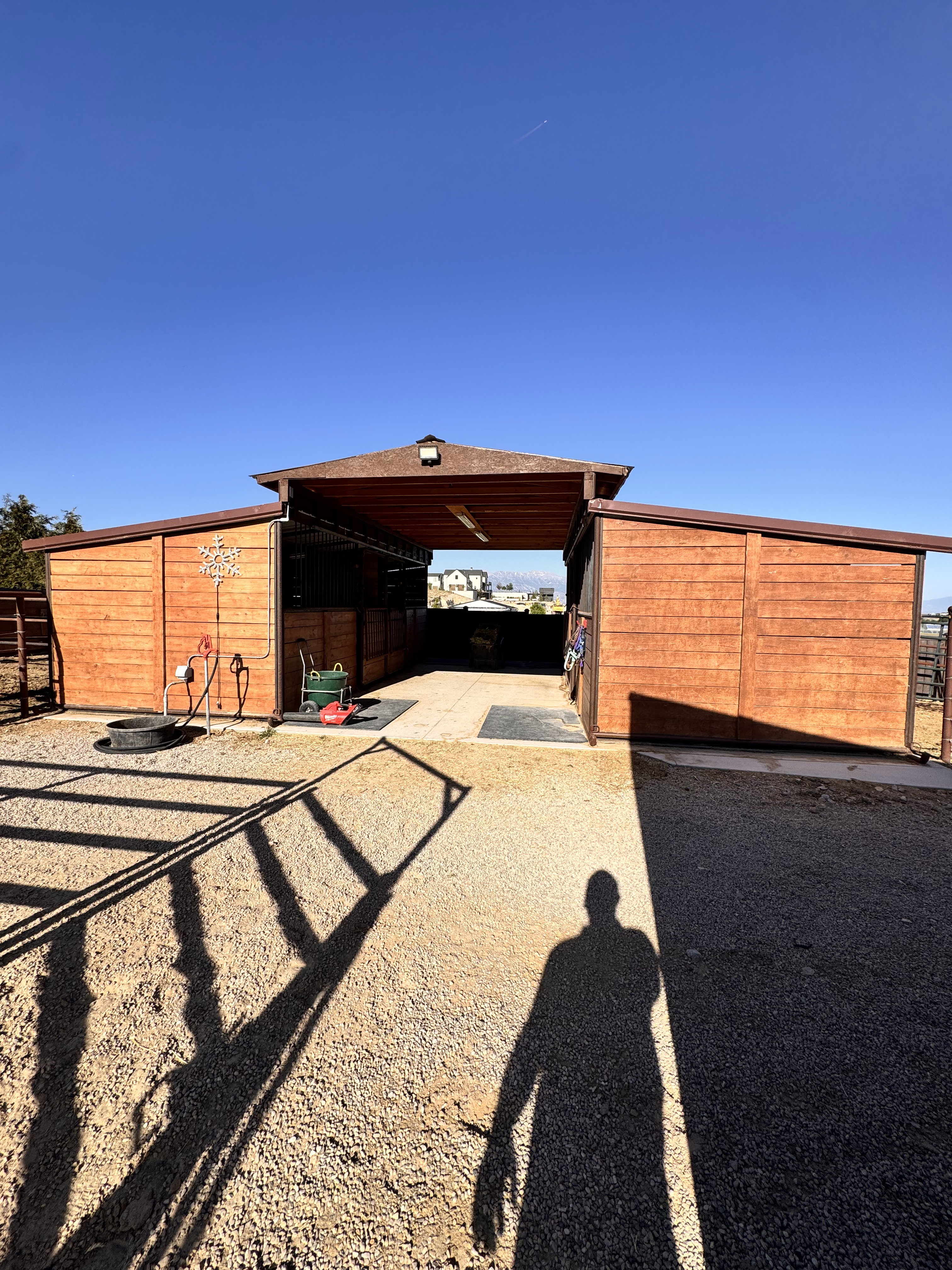 Wood-paneled outbuilding with a central breezeway and two covered wings