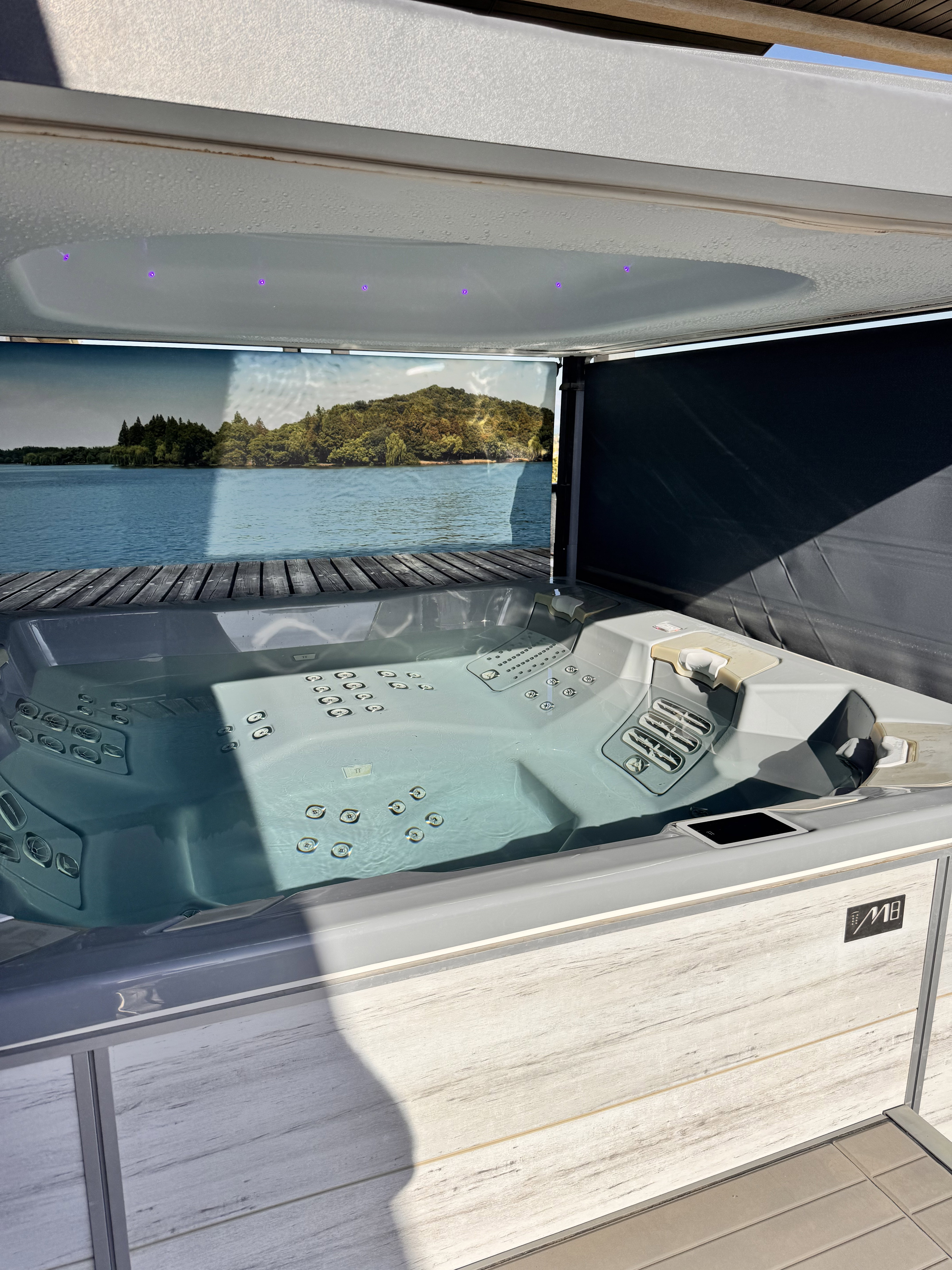 Integrated spa tub with a multi-jet design, interior lighting, and a wood-finish surround