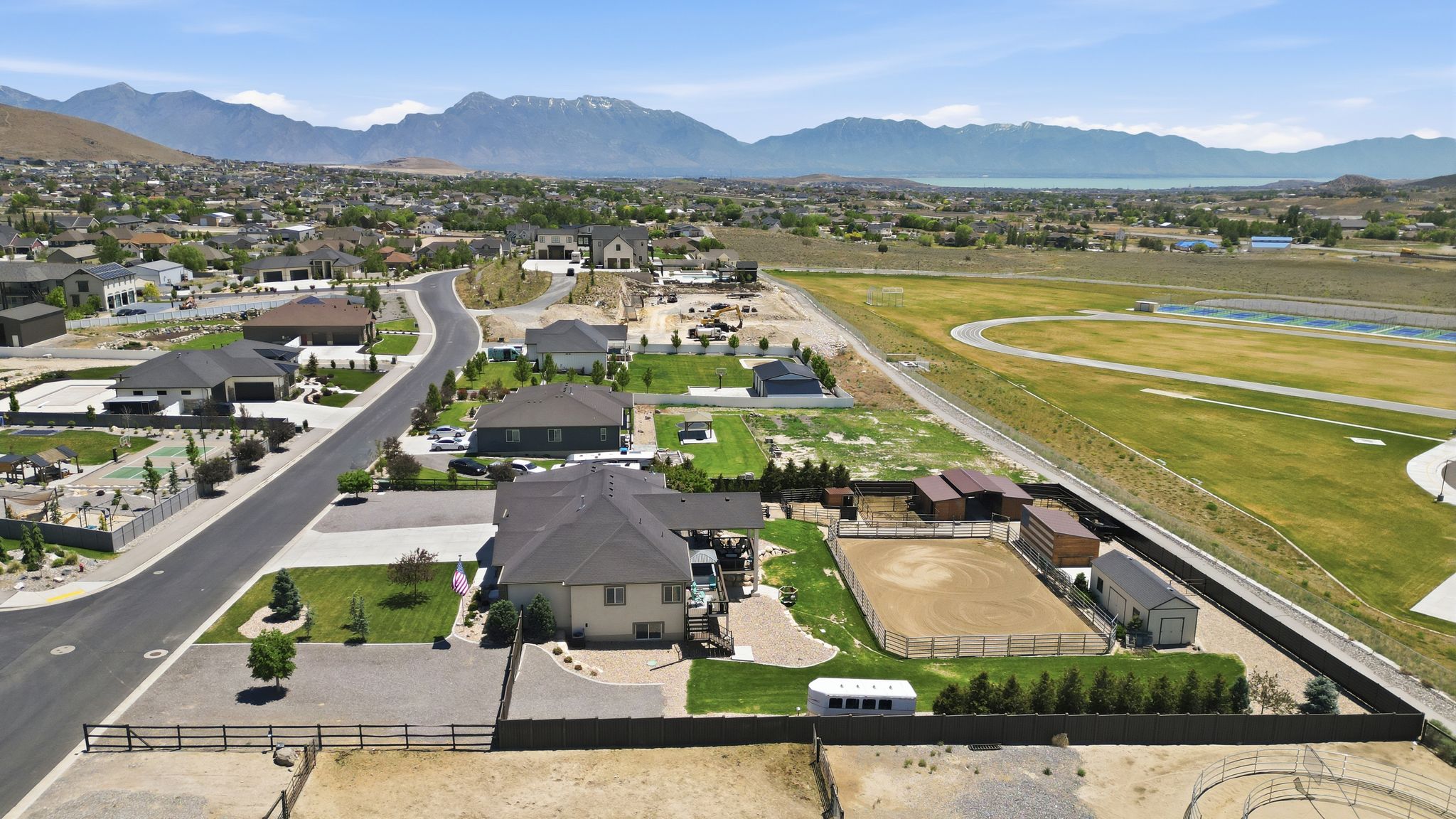Expansive property featuring a private equestrian arena, multiple outbuildings, and mature privacy landscaping